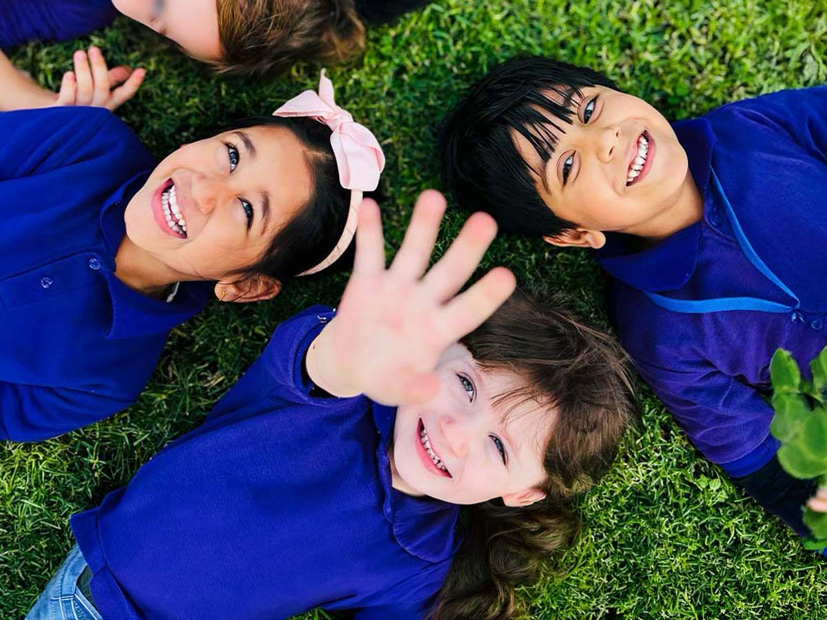 Happy Feet Nursery children sharing a joyful moment outdoors