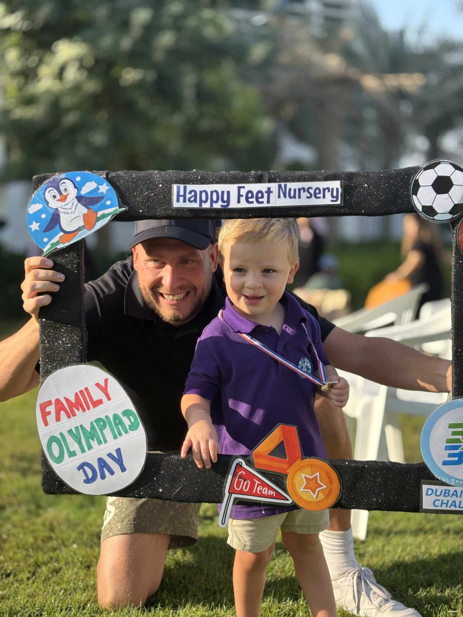 Adult and child celebrating Family Olympiad Day at Happy Feet Nursery