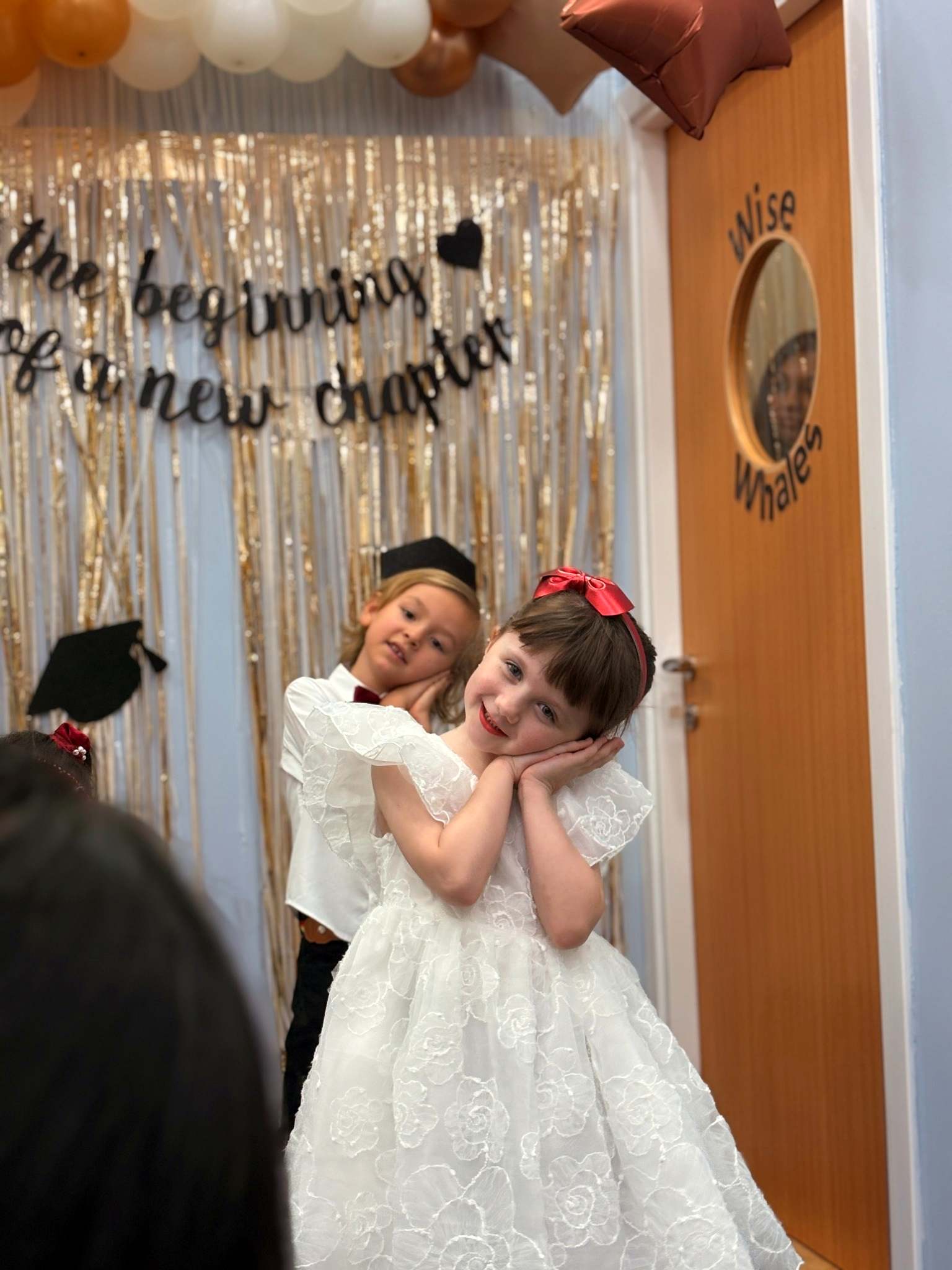 Children taking part in a nursery graduation celebration
